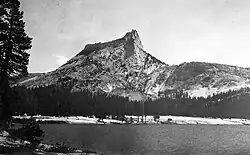 Photograph of Cathedral Peak rising above alpine lakes and surrounding granite terrain.