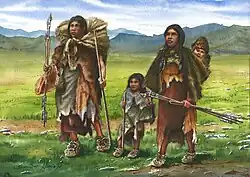 Family members standing with their gear as they arrive at their fall camp of Wilamaya Patjxa.