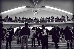 A crowd inside the terminal, as seen from the building's lower level