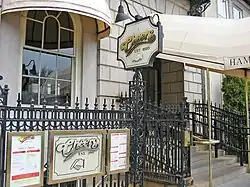 Sign reading, "Cheers est. 1985" highlighted by a manicule
