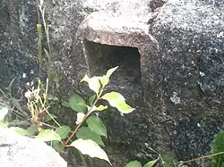 Color photograph of a masonry channel passing through an ancient wall