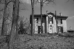Two-storey Italianate brick house known as Chiefswood in Ontario, with a low-pitched roof, wide eaves supported by brackets, and tall rectangular windows, photographed in 2008; the birthplace of poet E. Pauline Johnson.