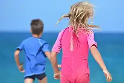 Children in blue and pink clothing.