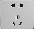 Old Chinese dual socket accepting both unearthed two-pin (upper) and earthed three-pin (lower) plugs