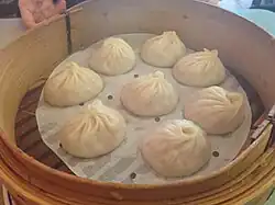 Image of chinese soup dumplings in bamboo steamer basket