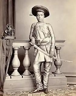 Portrait of the son of H.H. Chunnasee Rajoonath Pant, wearing churidars (1860)
