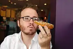 Author Christian Lander eating an everything bagel in Mar Vista, Los Angeles, California in 2008