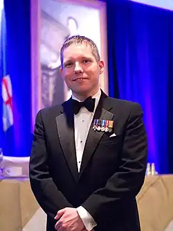 Portrait of Christopher McCreery wearing a suit