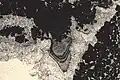 Stalactite cement at the top of a "keystone vug" typical of diagenesis in a vadose environment, at the top of an emersive cycle (L=0.3&nbsp;mm)