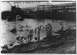 Children swimming nude in the East River in New York City around 1908