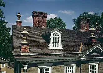 Urns, dormers and chimneys on the front roof