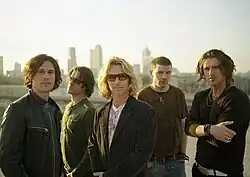 The band members standing side by side
