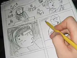 A hand pencils details on a page already largely filled with panels of a comic