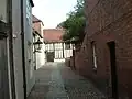 Entrance from beside Sidbury Gate, leading to the south front of the Great Hall 1470