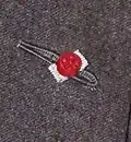 Rosette flanked both sides in silver, denoting the wearer has been awarded the Commander of the Legion of Honour