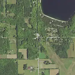 Aerial view showing Main Road intersecting Jackson Harbor Road. County Trunk Highway W (CTH-W) follows Little Lake Road (upper left), which curves south to join Main Road. Washington Harbor is at the upper right.