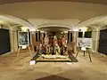 The 15th century wooden Lamentation group, flanked by two paintings by Ugo Bacchetta
