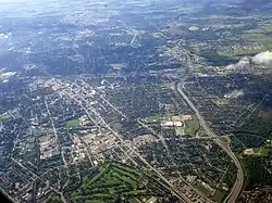 An aerial photograph of an urban area, with the Conestoga Parkway visible from the foreground into the distance
