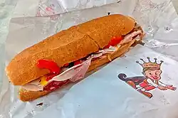 cut roll sandwich on a paper wrapper