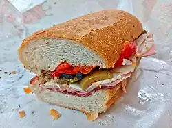 cut roll sandwich on a paper wrapper