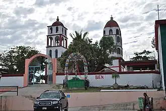 A white and red church building in the distance