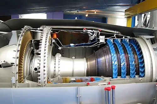 Rolls-Royce Turbomeca Adour military turbofan. There is a requirement to maintain a certain minimum pressure-loss in combustors, rather than reducing it as much as possible to minimize entropy production. It has to be maintained to prevent backflow in the turbine cooling circuits since cooling air from the HP compressor needs a lower pressure at the turbines in order to flow.[93][94] Cooling air from the compressor (blue) has to flow to the turbine area (nozzle guide vane painted orange). This is enabled by the drop in pressure which occurs in the combustor. Also evident is the increase in area from the compressor into the combustor which is necessary to slow the air.