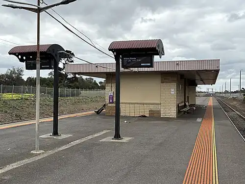 Corio station Platform 2 looking north, showing station building on the island platform