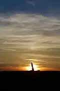 The Longstone in front of the setting sun