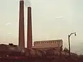 View of Courtaulds Chimneys with Boiler House visible in background and a caustic soda tank train delivering