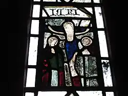 Detail of the medieval glass in the second lancet on the north side of the chancel