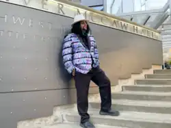 DJ Cummerbund posing outside of McCaw Hall in Seattle, 2022