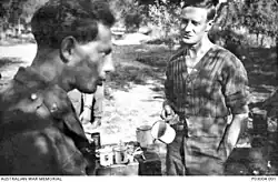 Black and white image of two men drinking tea