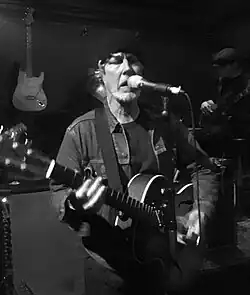 A photo of a live performance by Johnston
