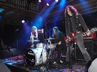 Dead Moon performing live in 2015; from left to right: Toody Cole, Andrew Loomis, and Fred Cole.