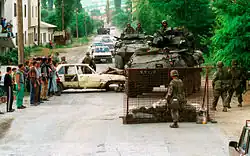 U.S. Marines from the 2nd Light Armored Reconnaissance Battalion set up a road block to check for weapons near the village of Koretin, Kosovo, on June 16, 1999