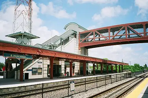 A railway station with two side platforms and a footbridge