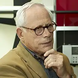 Portrait of subject with hand on chin.