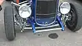 Deuce coupe featuring '32 grille shell, original headlights, chrome dropped I-beam axle and tube shocks. Note stock frame rails, disc brakes, Lakester pipes[58]