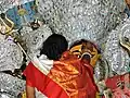 A woman dressed in garad sari devi baran (welcomes the goddess) on Bijoya Dashomi.