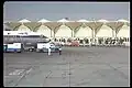 An aircraft parked in front of the terminal