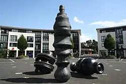 three unidentifiable elements, one like a tall figure or column