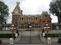 A flight of stairs leads to an old-fashioned railroad station building.