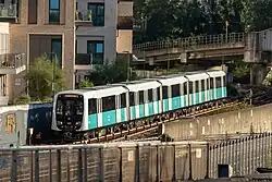 B23 stock DLR train departing Canning Town station for Woolwich Arsenal