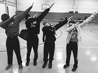 A group of teens dabbing, a popular fad and gesture of the youth around 2015–2016. Dabbing was the most prominent dance trend of the 2010s, which joined such dances as Flossing and the Harlem Shake.