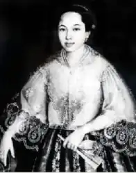 Monochrome reproduction of portrait of a Filipino woman in a lacy top, holding a fan