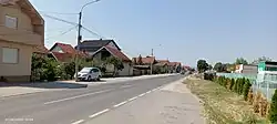 A residential street lined on one side by houses.
