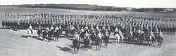 A group of soldiers on horseback in black and white