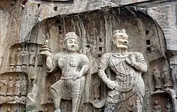 Large size Buddhist statues carved in stone from a cliff wall