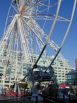 Four-car 30&nbsp;m tall drive-in Ferris wheel at Harbourfront, Toronto, Canada, in 2004[186]