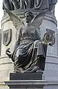 One of the four winged figures at the base of the monument